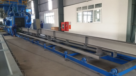 Máy Phun Bi Băng Tải Con Lăn